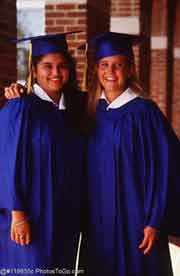 Two women in graduation gowns; Actual size=180 pixels wide